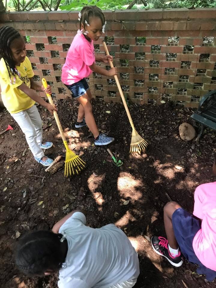 Children raking and digging in dirt