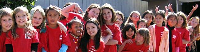 Group of children in red shirts posing together
