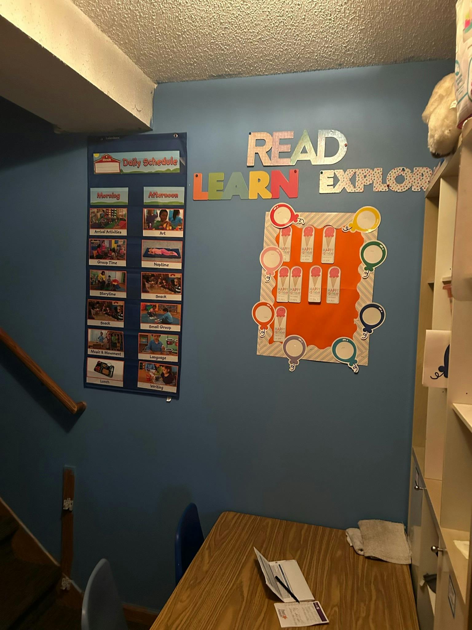 Wall with "READ LEARN EXPLORE" text and educational charts