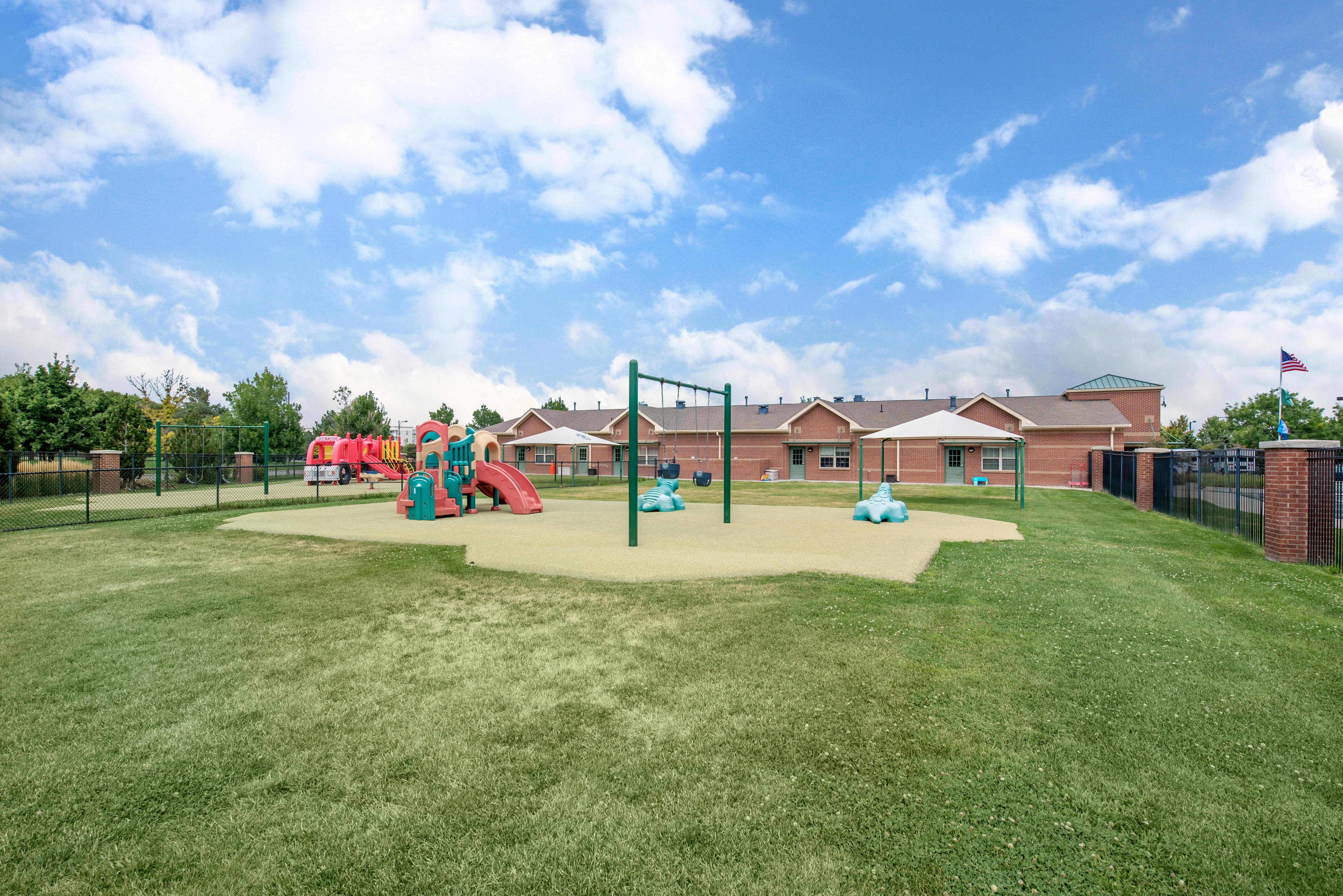 Playground with slides and monkey bars on a grassy field