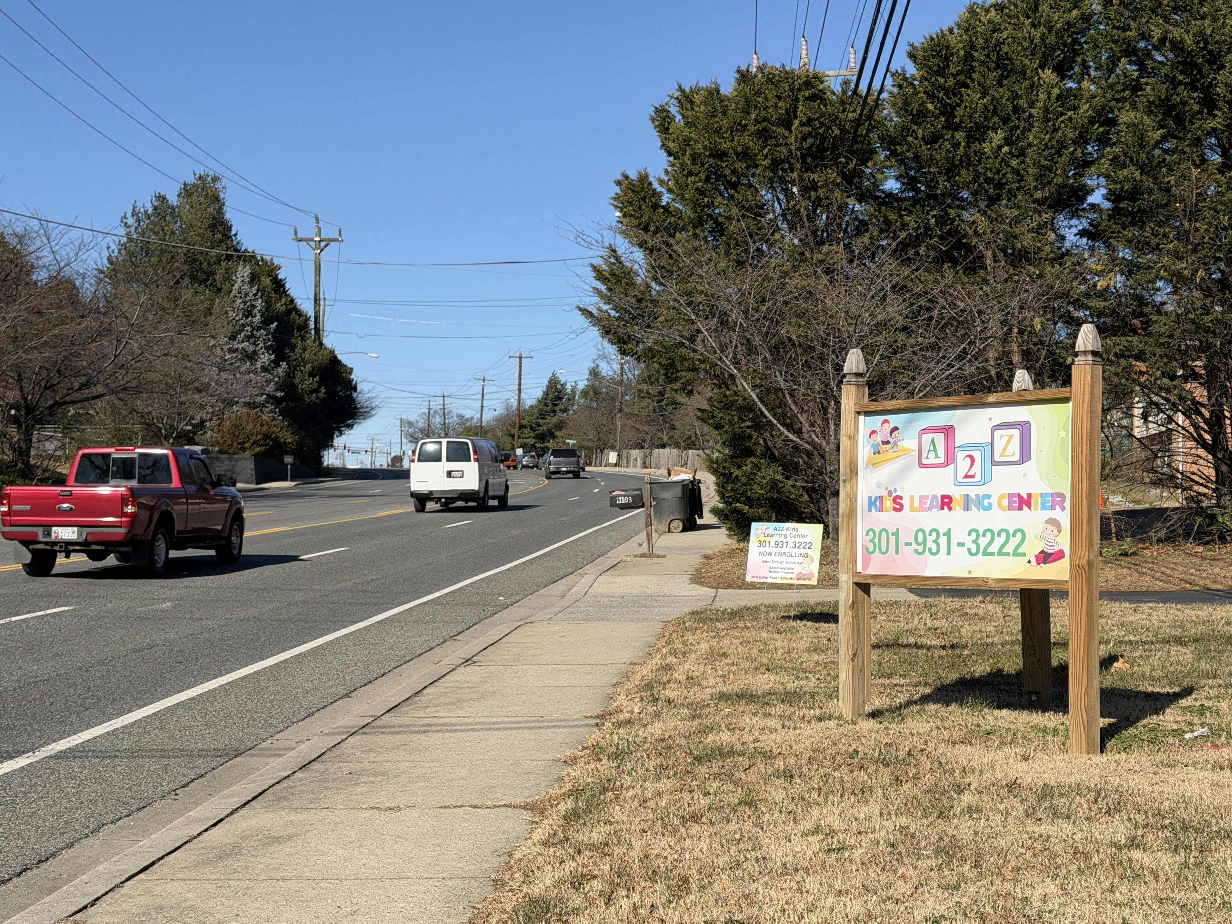 A2Z Kids Learning Center sign with phone number next to a road
