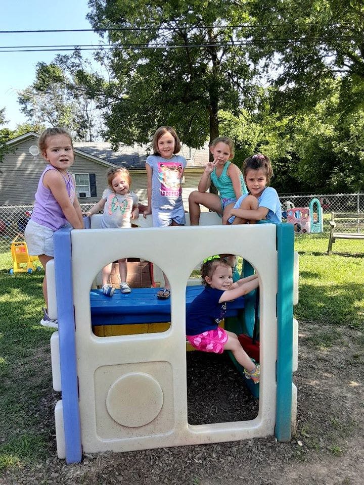 Children playing on a small outdoor play structure