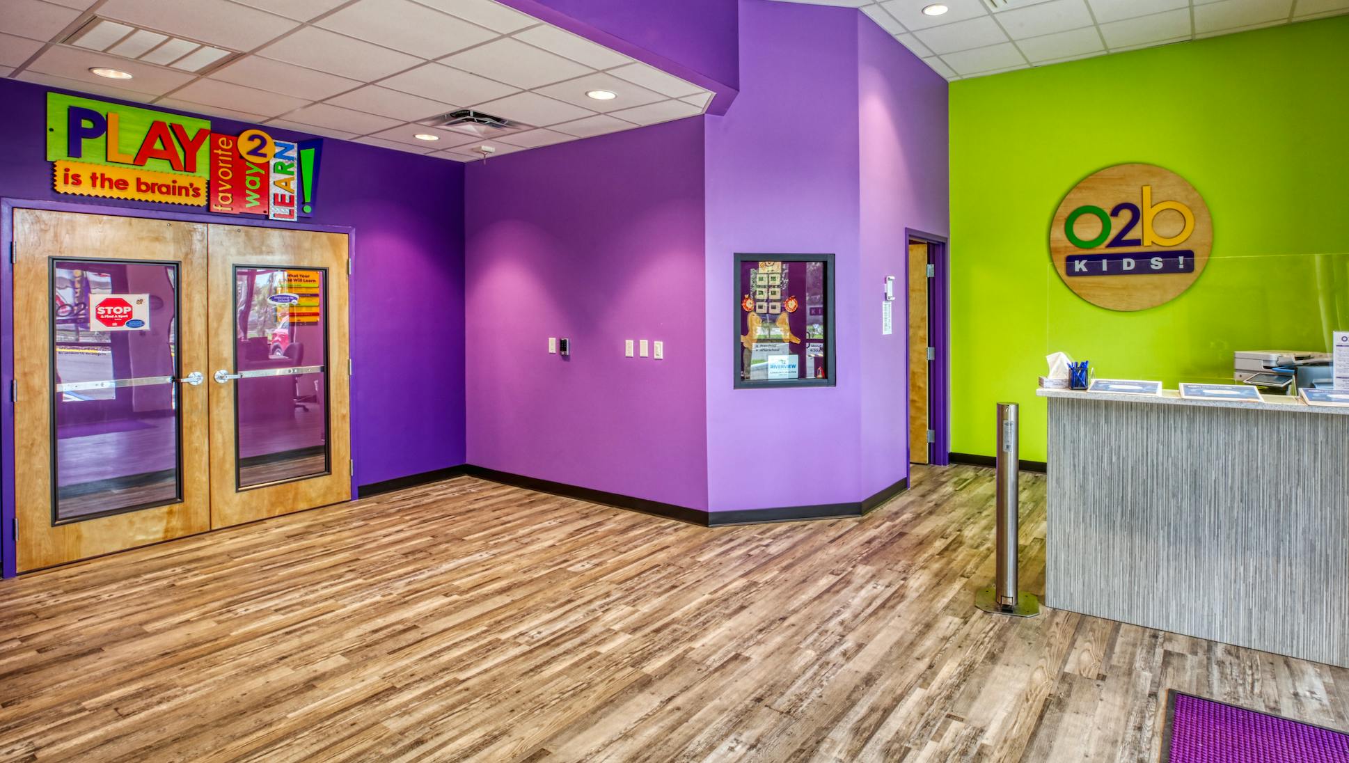 Lobby of a children's learning center with purple and green walls