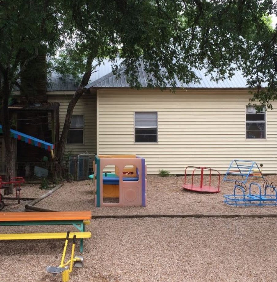 Playground with various equipment in front of a building