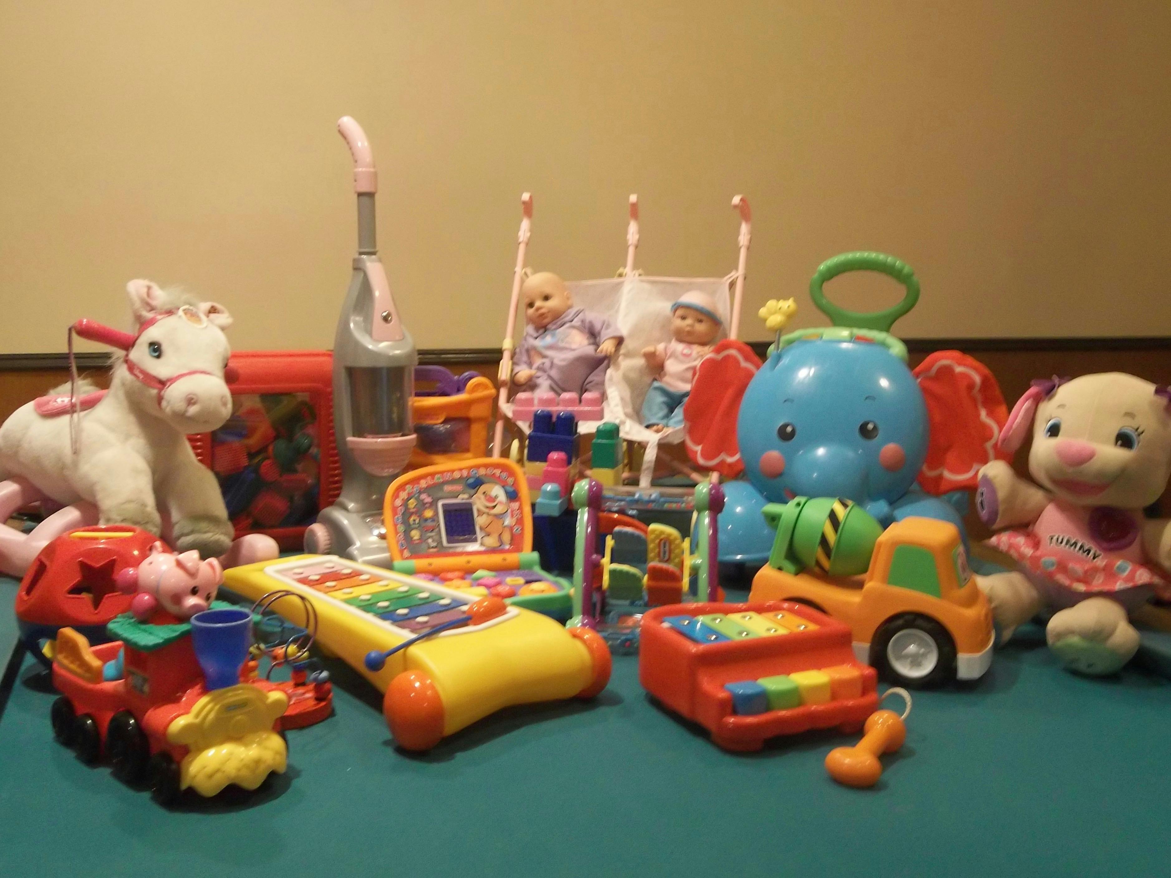 Assortment of children's toys including stuffed animals, dolls, and plastic play items