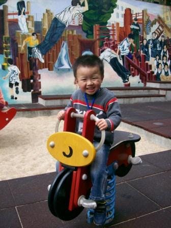 Child on a spring rider in a playground