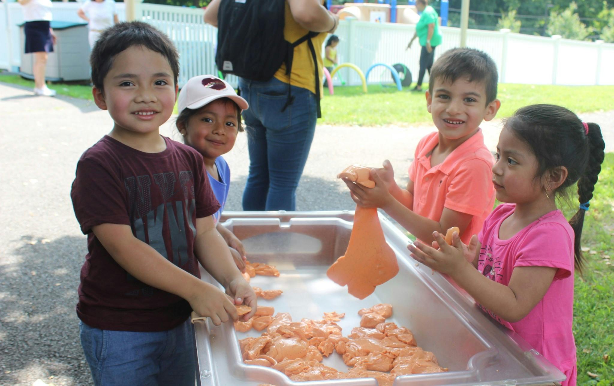 Children playing with sand in a sand table