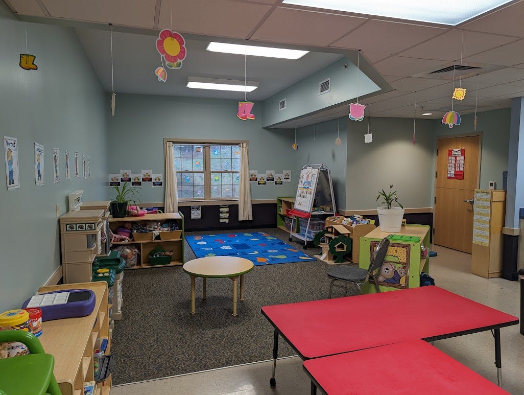 Classroom with small tables, chairs, and toys