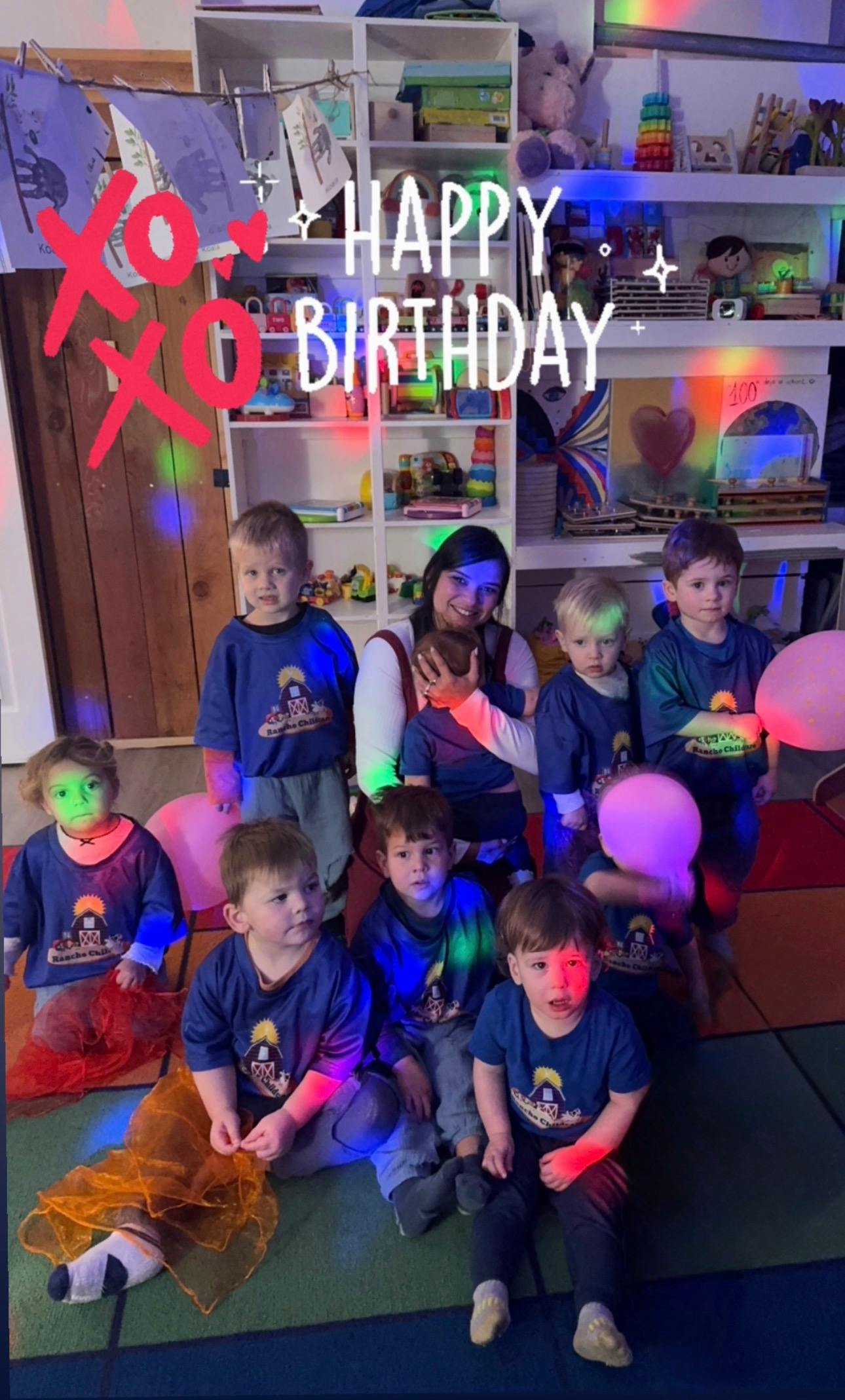 adult and children in a room with \"Happy Birthday\" overlaid