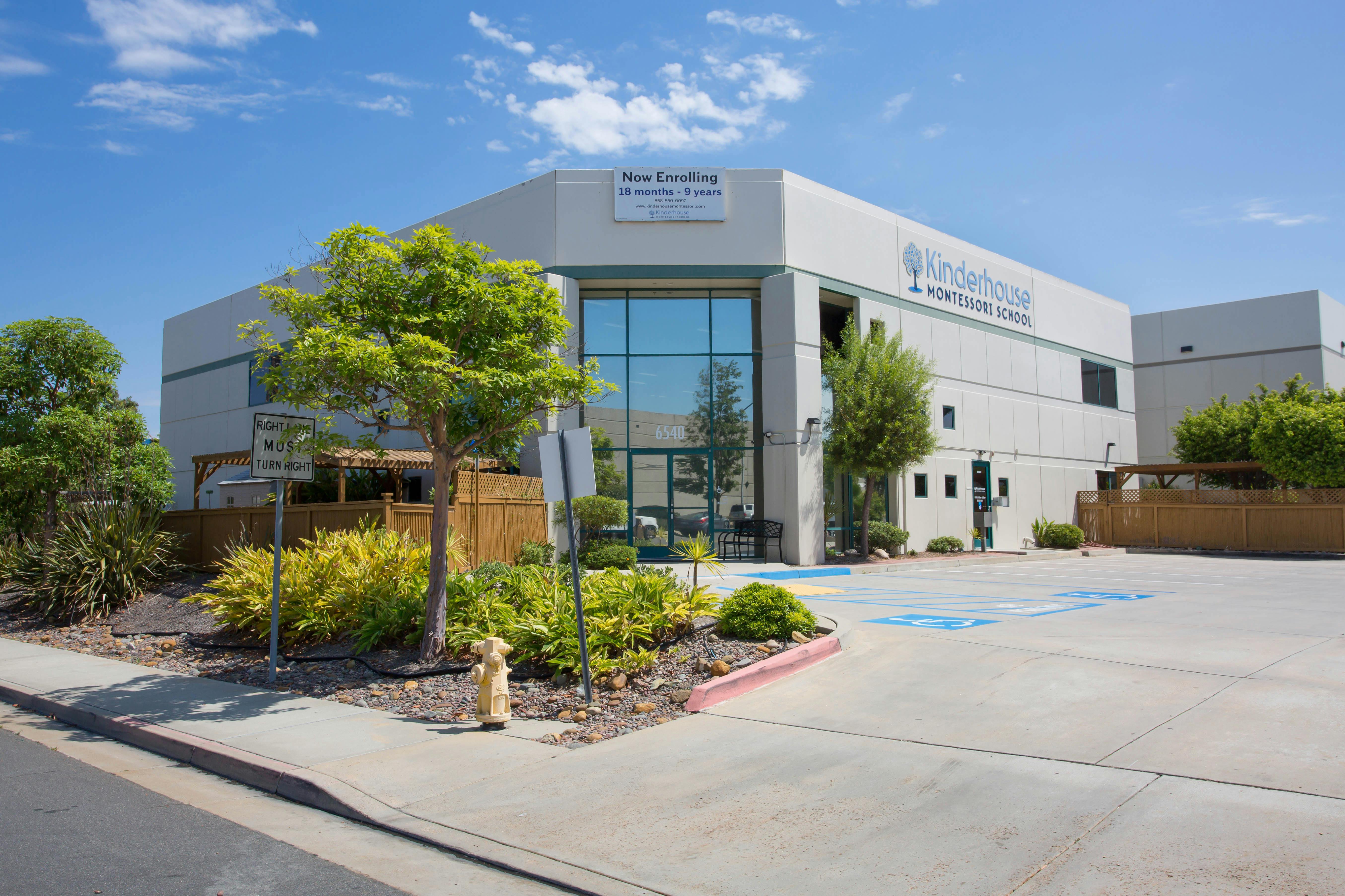 Exterior of a commercial building with a parking lot and landscaping