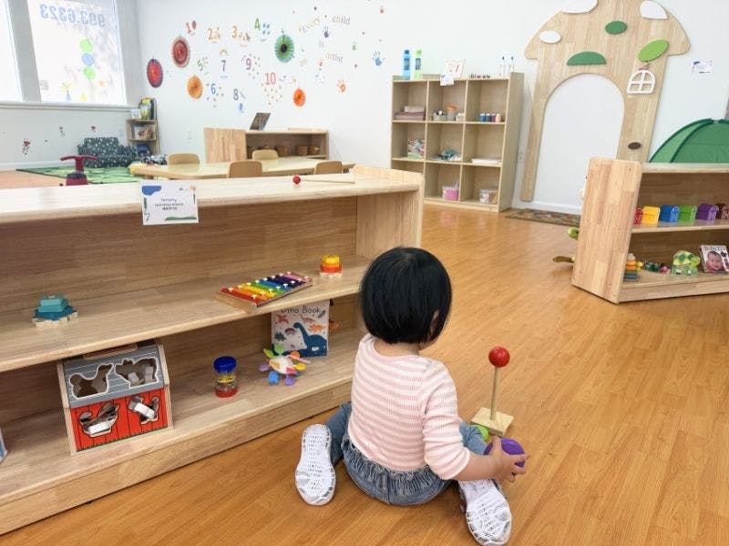Child sitting on the floor in a classroom