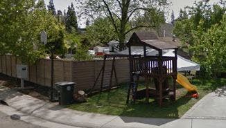 Playset with slide and swings in a yard