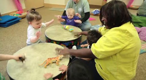 Adults and children playing drums