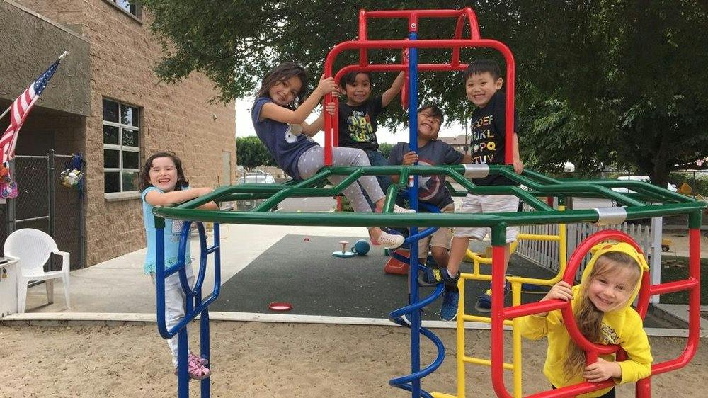 Children playing on a colorful playground structure