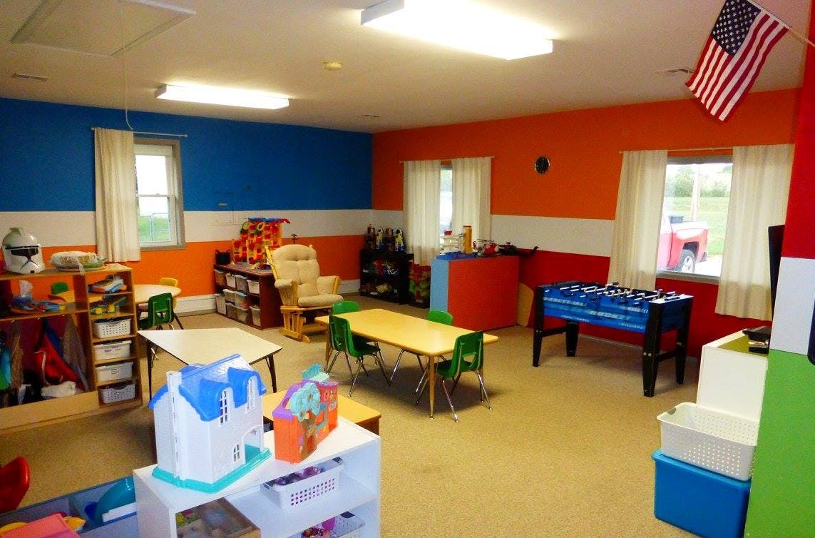 Playroom with tables, chairs, and a foosball table