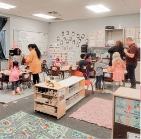 Adults and children in a classroom