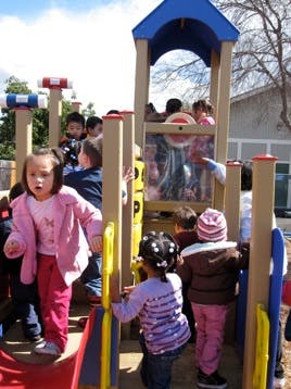 Children playing on a playground structure