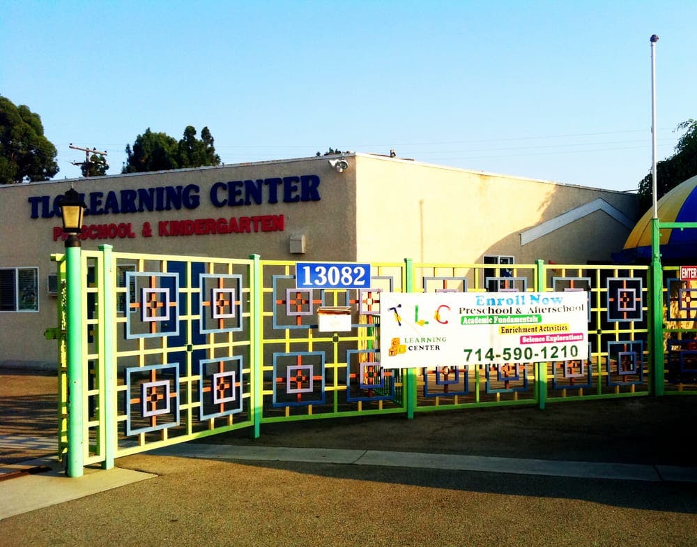 TLC Learning Center building behind a decorative fence with a sign