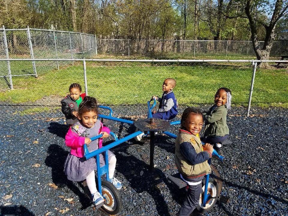Children playing on a merry-go-round at a playground