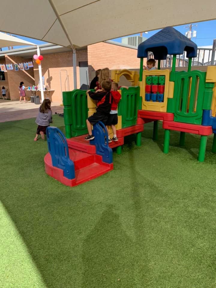 Children playing on a colorful playground structure