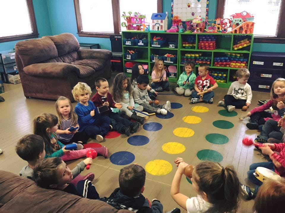 Children sitting on the floor in a circle in a classroom