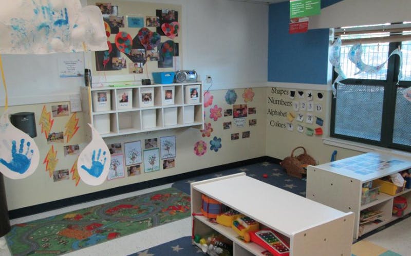 Children's classroom with artwork, cubbies, and learning materials on the walls