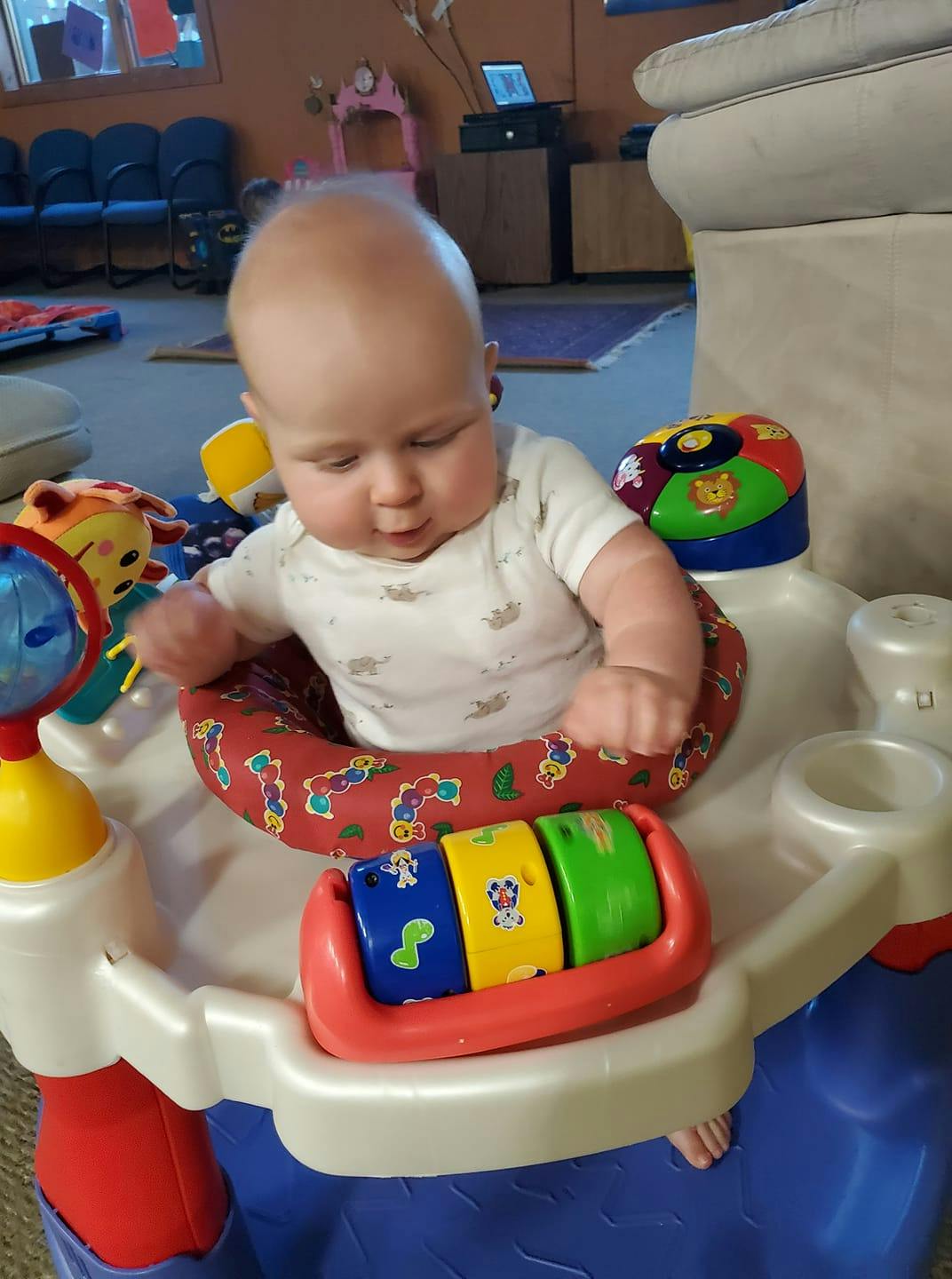 Child in a baby activity center