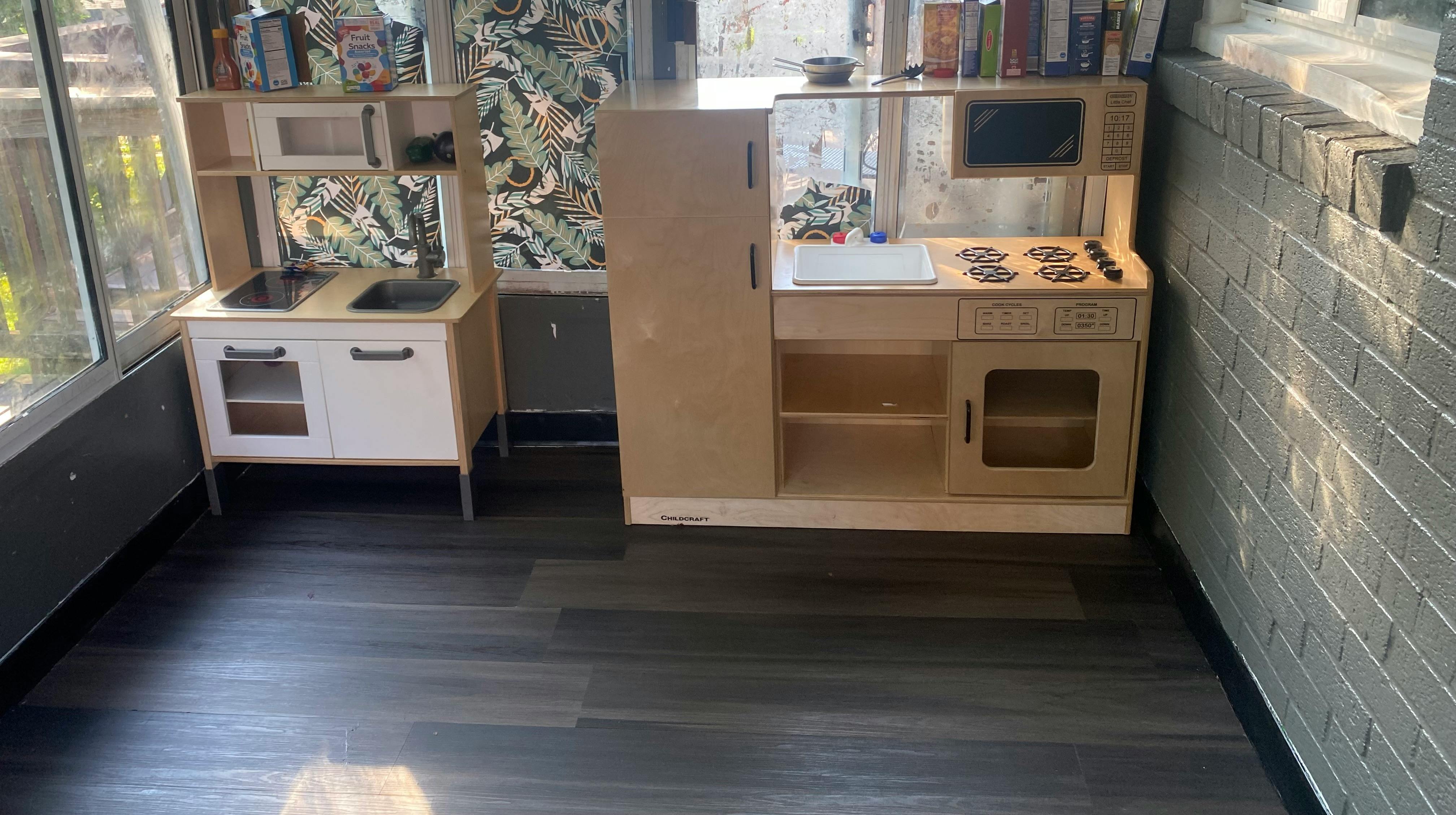 Two toy kitchens in a room