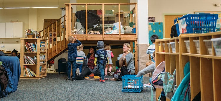 Adults and children gathered in a classroom