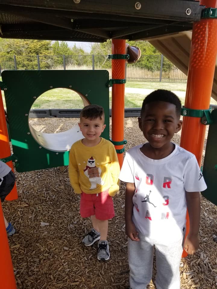 Two children standing on a playground