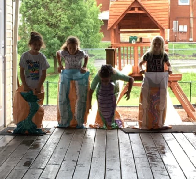 Four children in sacks for a sack race