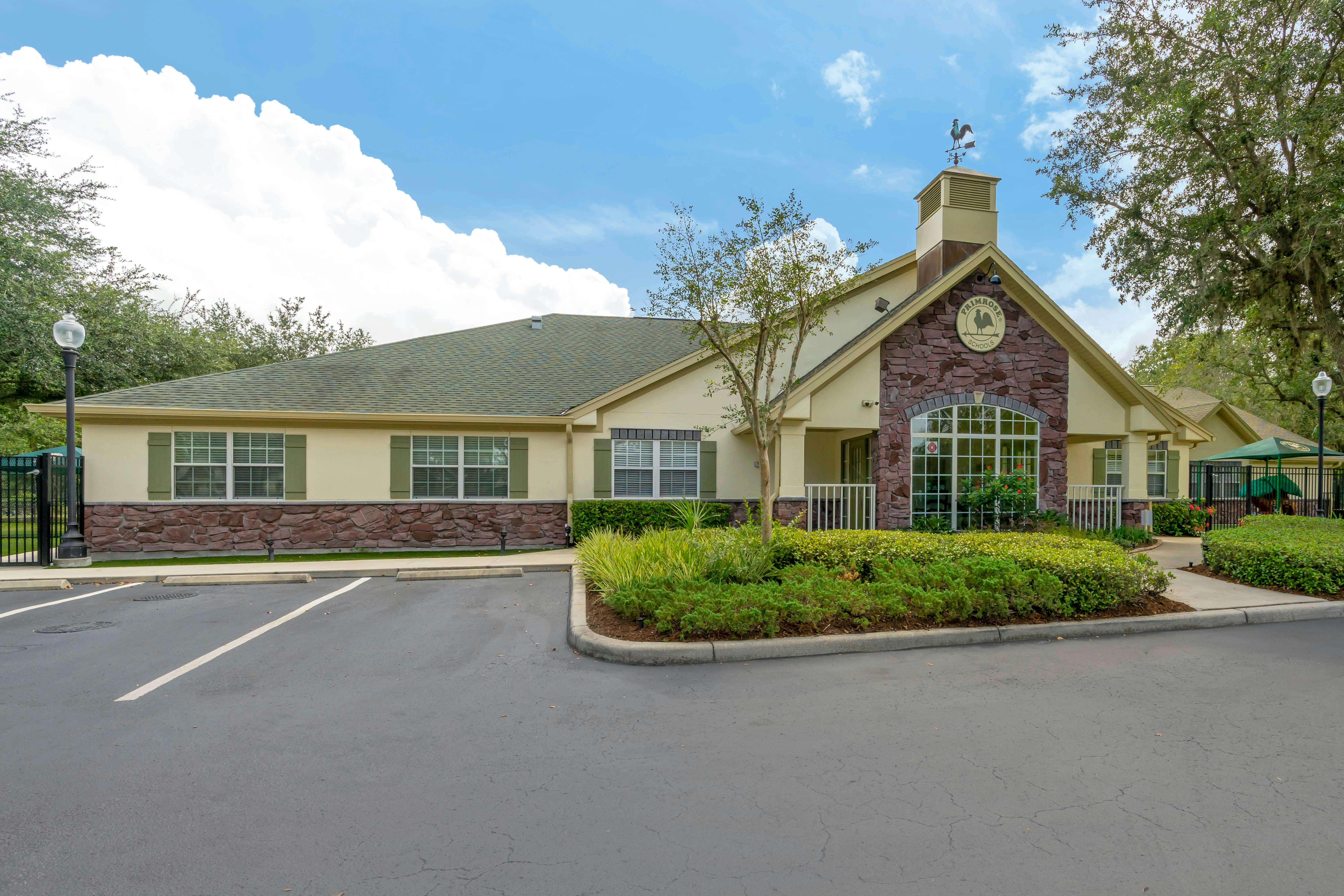 Exterior of a Primrose Schools building with a parking lot and landscaping
