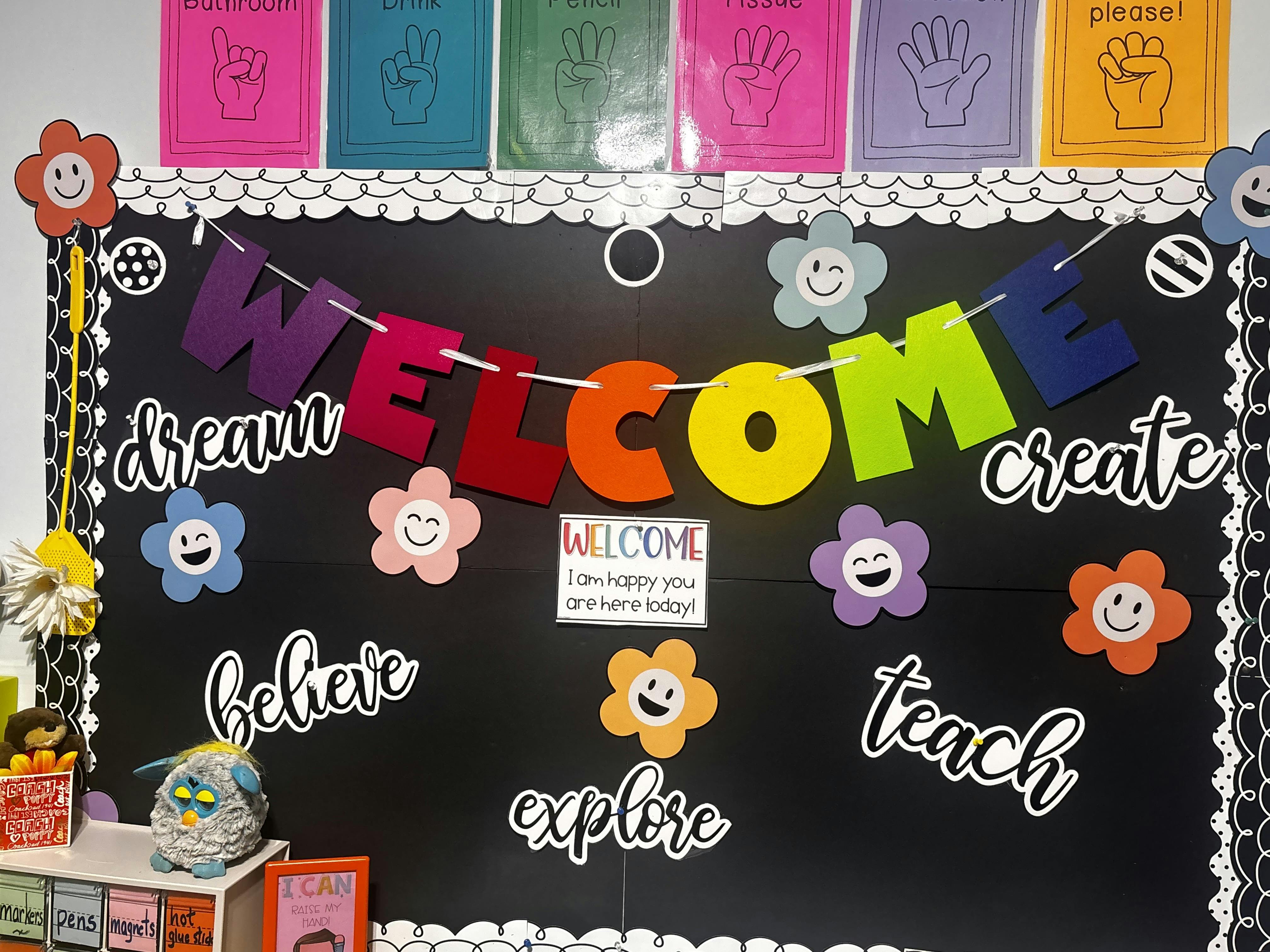 Classroom bulletin board with colorful "WELCOME" banner and sign language cards