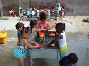 Children playing with water table outdoors