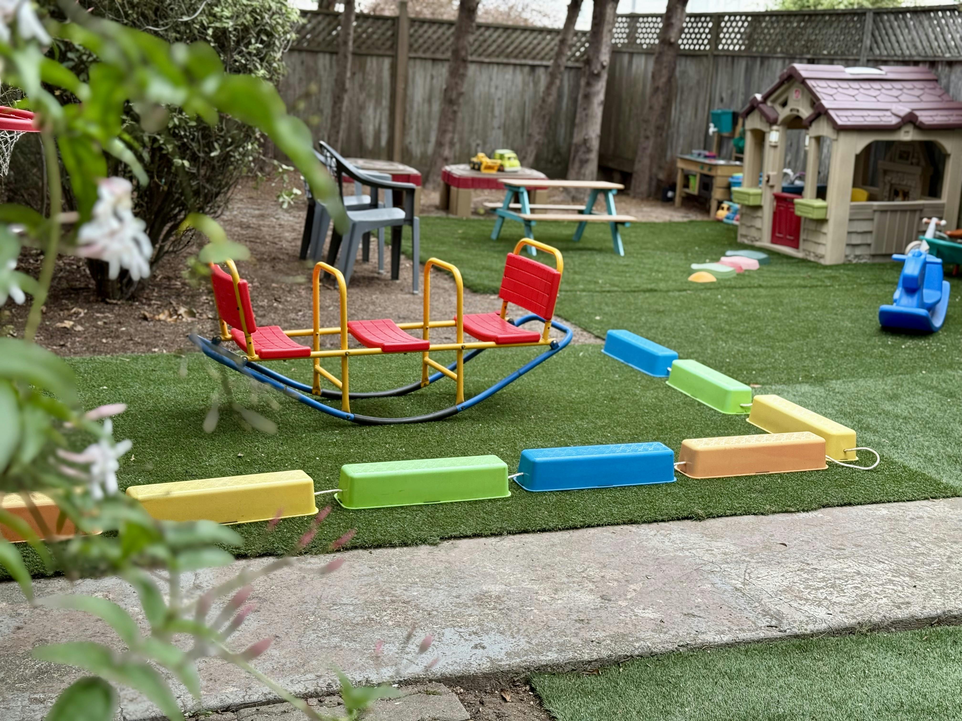 Playground with a four-seat seesaw and colorful balance beam