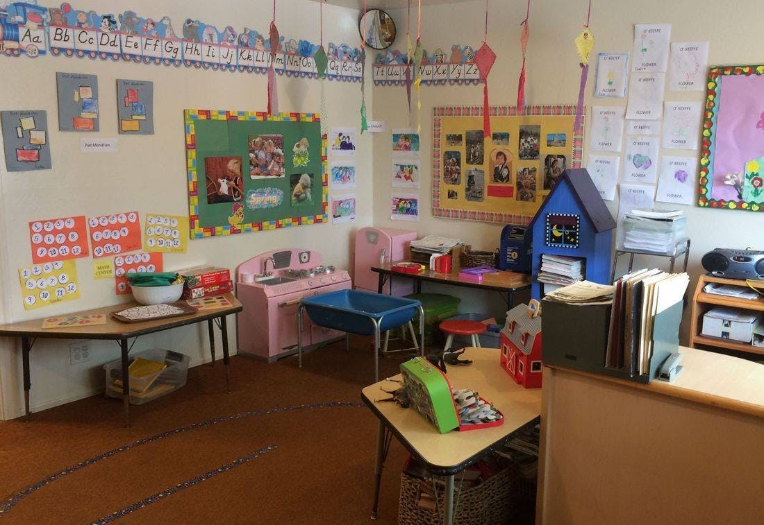Classroom with small tables and chairs, decorated walls