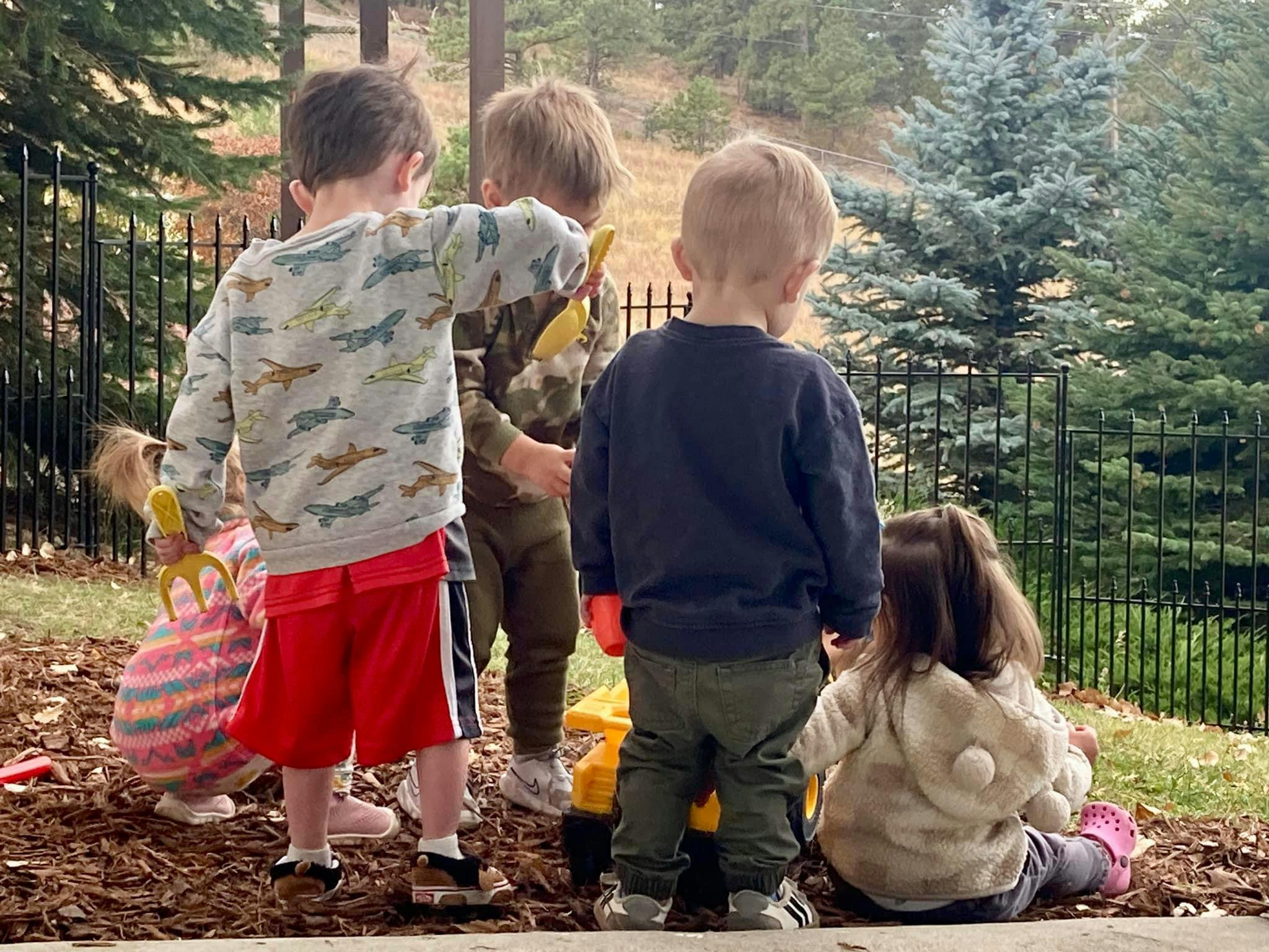 Children playing outdoors with toys