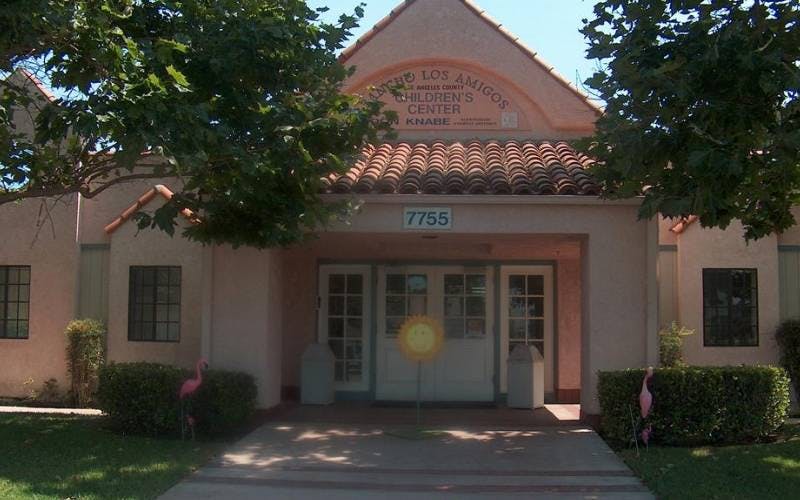 Entrance to a children's center with a prominent sign and building number
