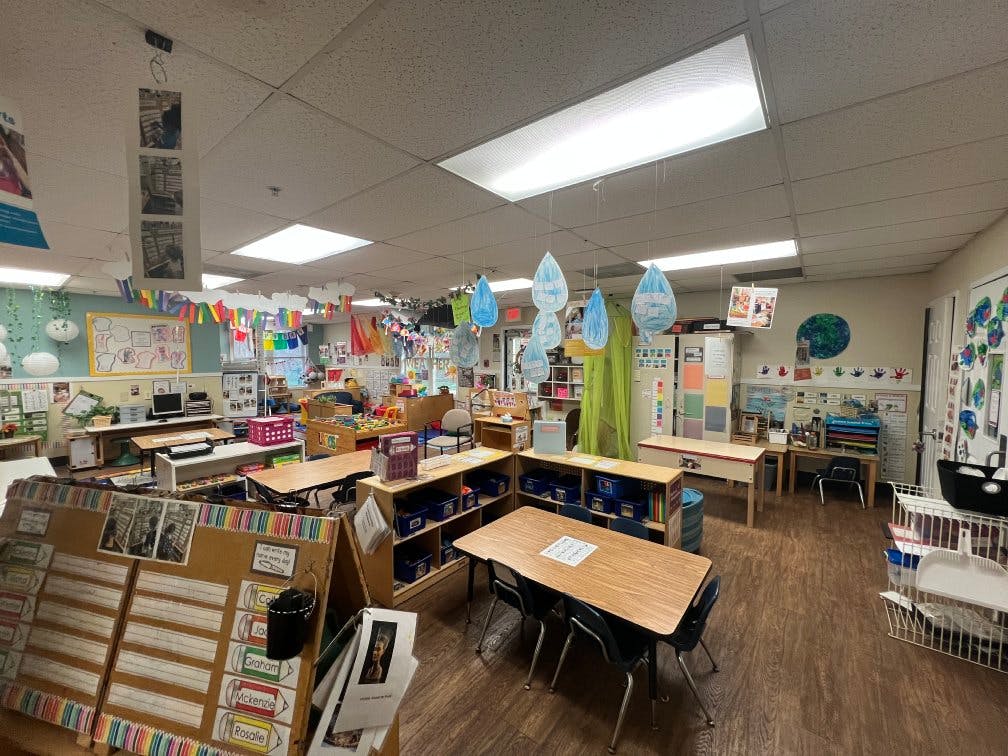Classroom with tables, chairs, and colorful decorations
