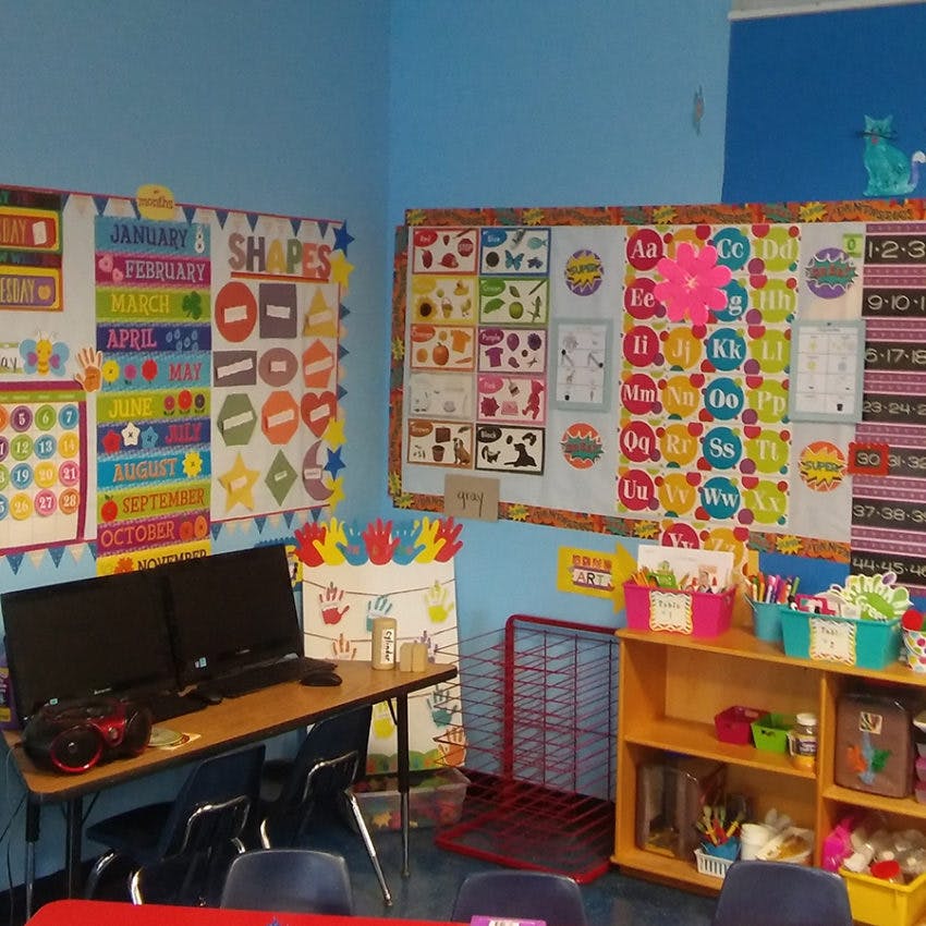 Classroom with educational posters on walls and desks with computers