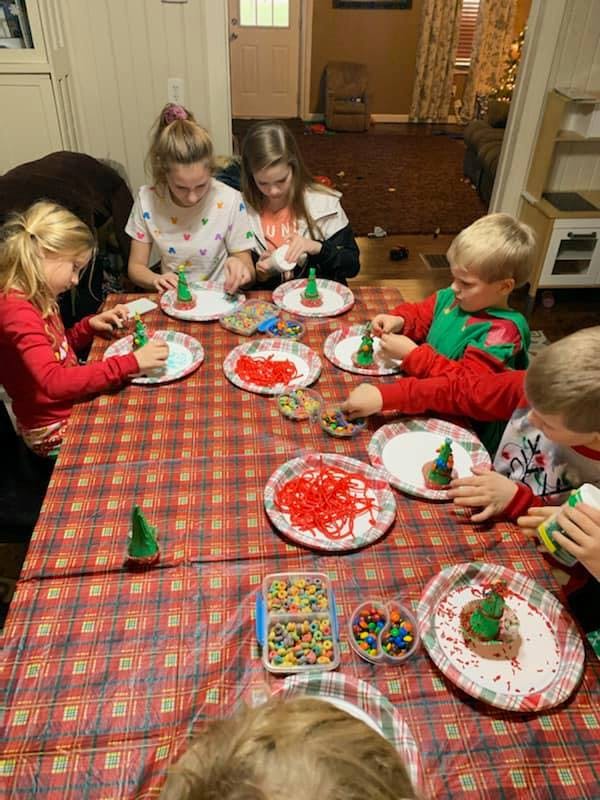 Children decorating cookies at a table