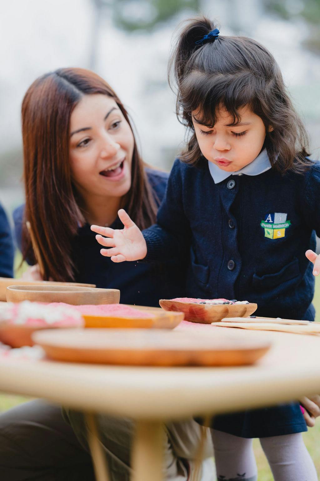 Adult and child looking at items on a table