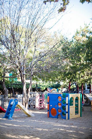 Playground with slides and climbing structures on sand