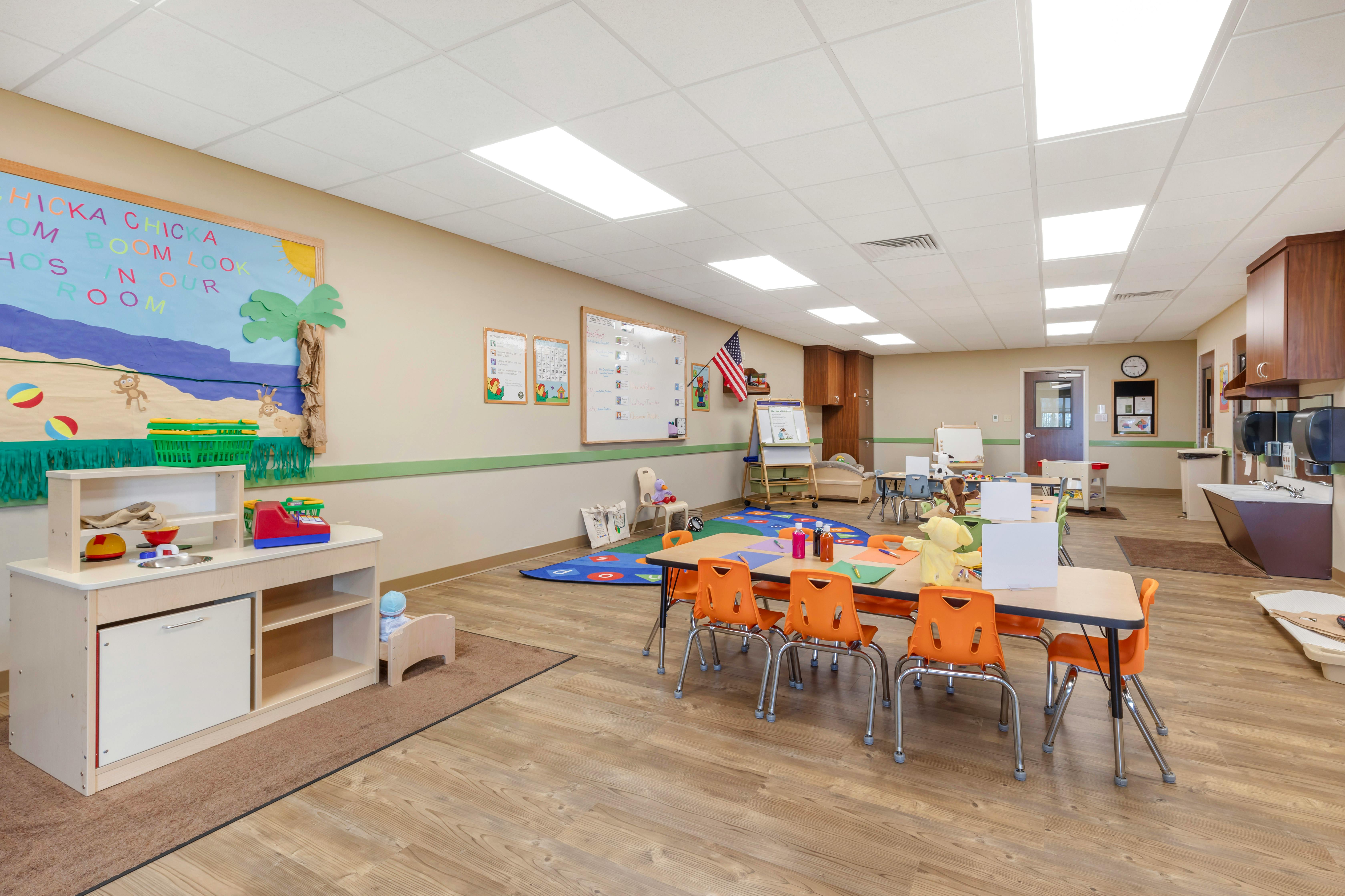 Colorful classroom with child-sized furniture and play kitchen