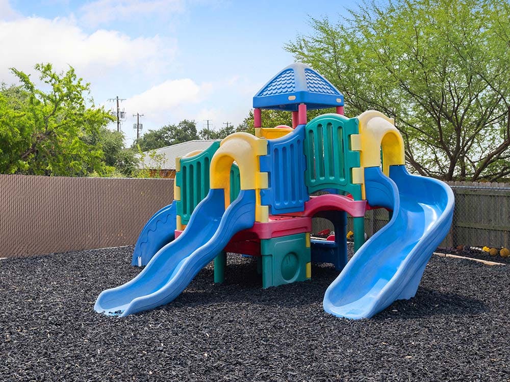 Colorful playground structure with two blue slides