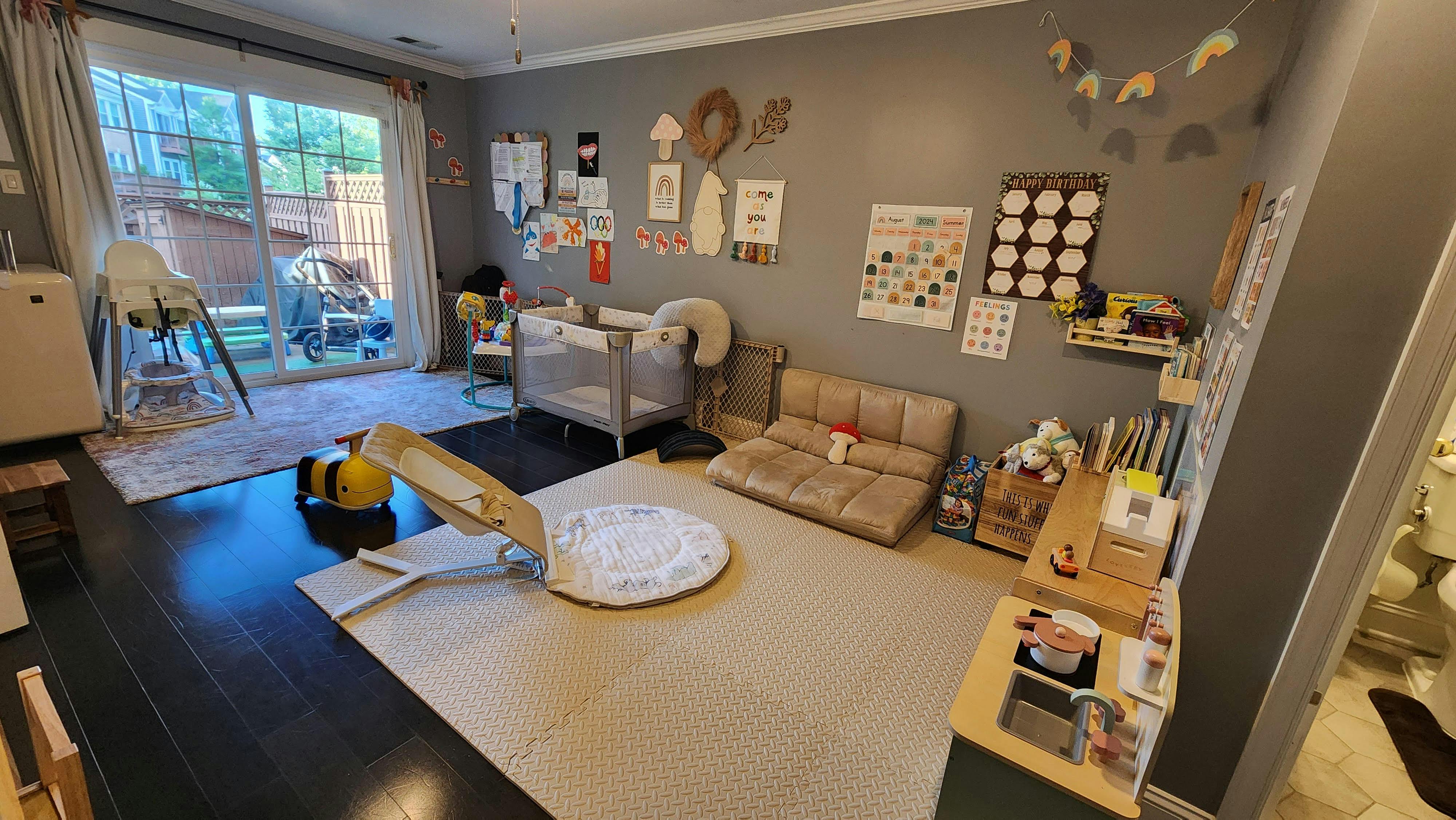 Playroom with a crib, small slide, and various toys