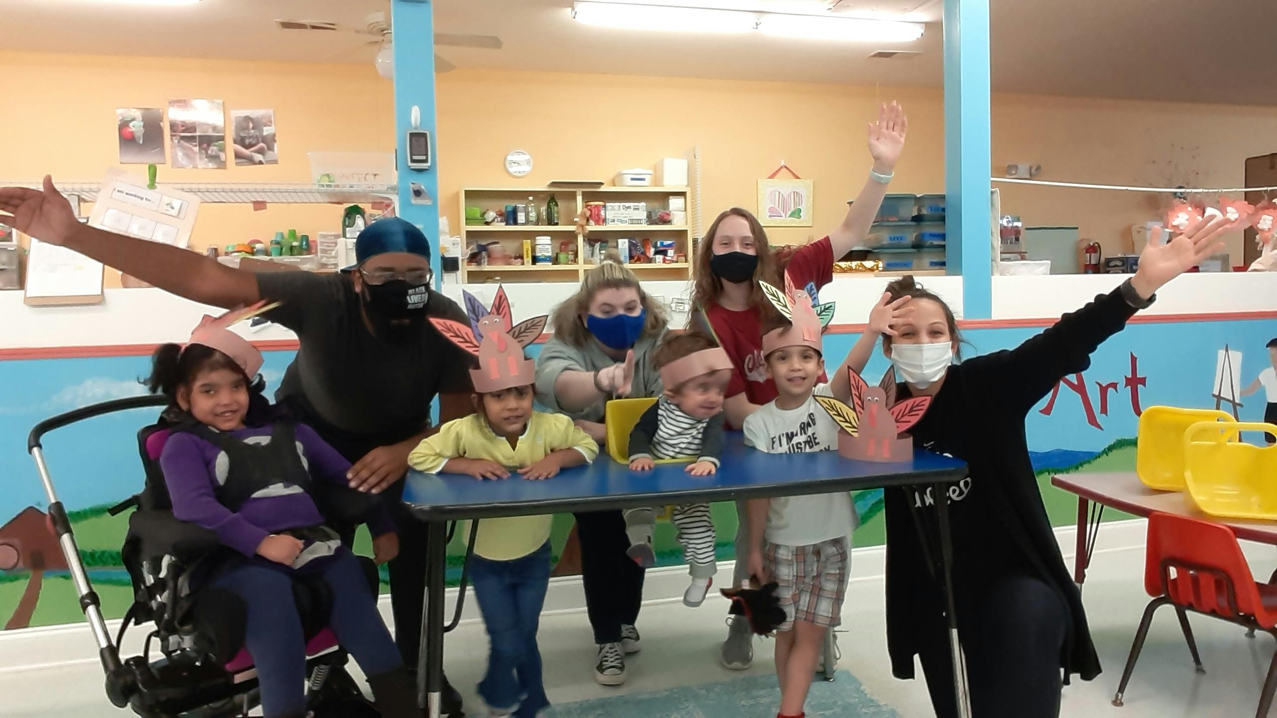 Adults and children wearing bunny ears, some waving