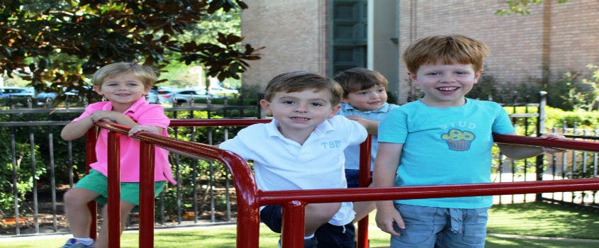 Four children on playground equipment