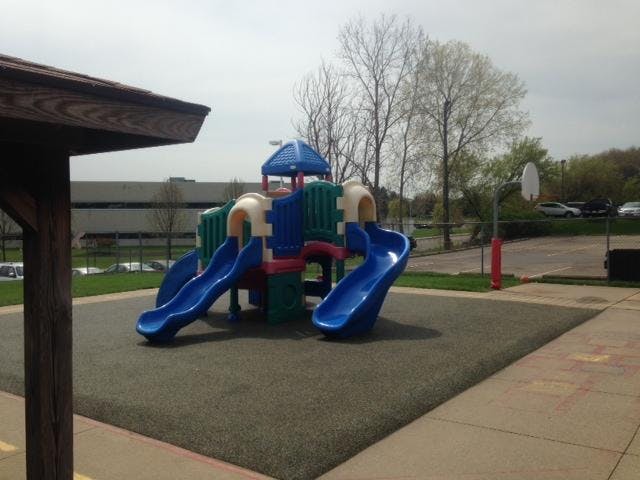 Playground with multiple slides on a rubberized surface