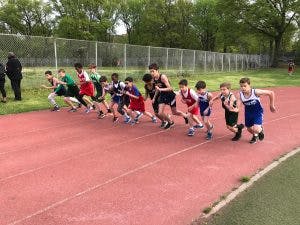 Children and teens at the starting line of a track race